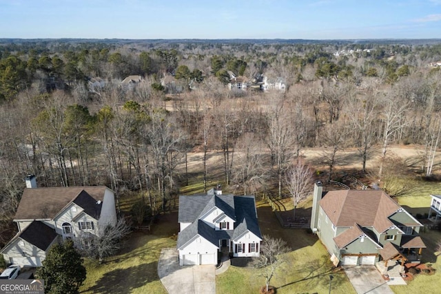 birds eye view of property with a forest view