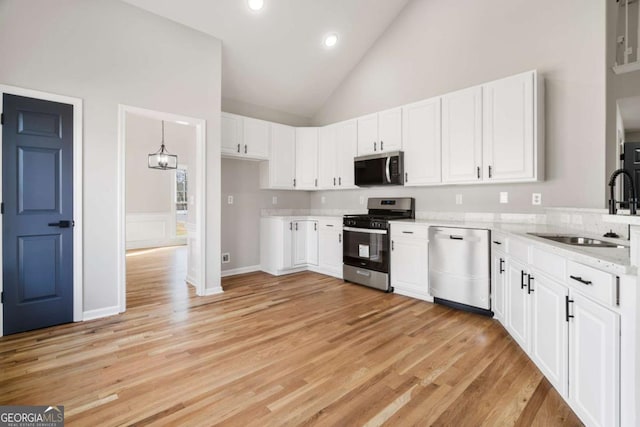 kitchen featuring stainless steel appliances, sink, and white cabinets