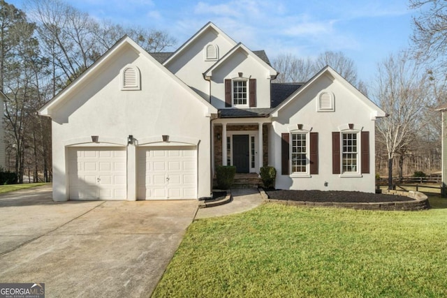 view of front of house featuring concrete driveway, a front lawn, a garage, and stucco siding