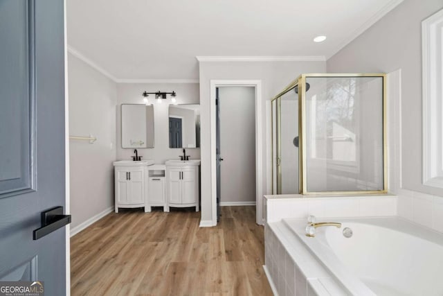 bathroom featuring independent shower and bath, vanity, hardwood / wood-style flooring, and crown molding