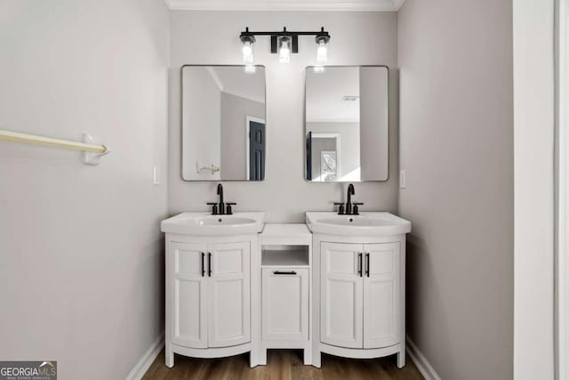 bathroom featuring hardwood / wood-style flooring, vanity, and crown molding