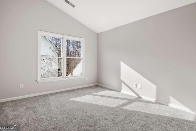 unfurnished room with lofted ceiling and light colored carpet