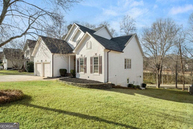 view of home's exterior with a garage and a lawn