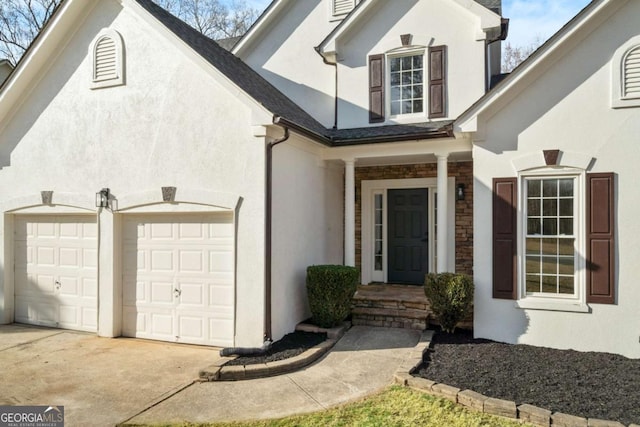 view of exterior entry with a garage