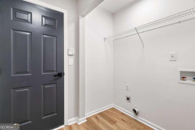 laundry area with hookup for a washing machine, electric dryer hookup, and hardwood / wood-style floors