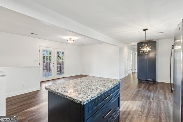 kitchen with stainless steel fridge, blue cabinetry, french doors, and a kitchen island