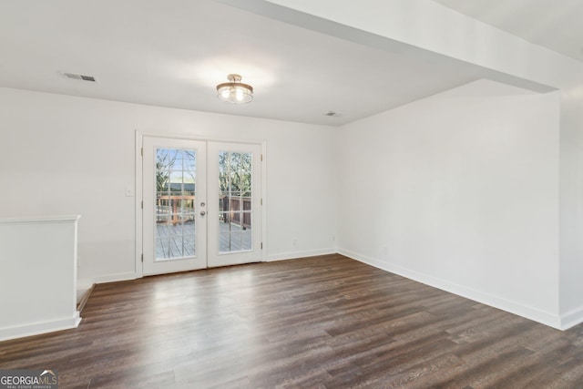 empty room with dark wood-type flooring and french doors