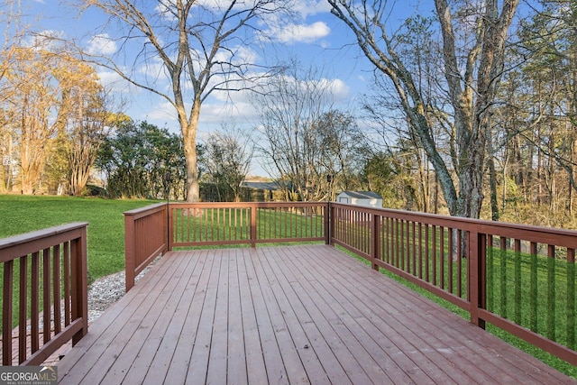 deck with a yard and a shed