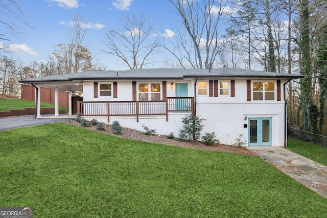 view of front of house with french doors, a carport, and a front yard