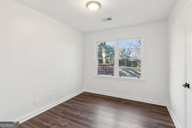 empty room with dark hardwood / wood-style floors