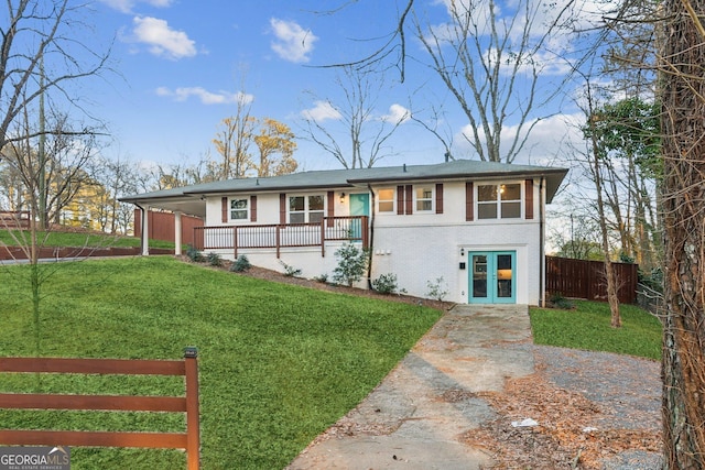 view of front of house with a front yard and french doors