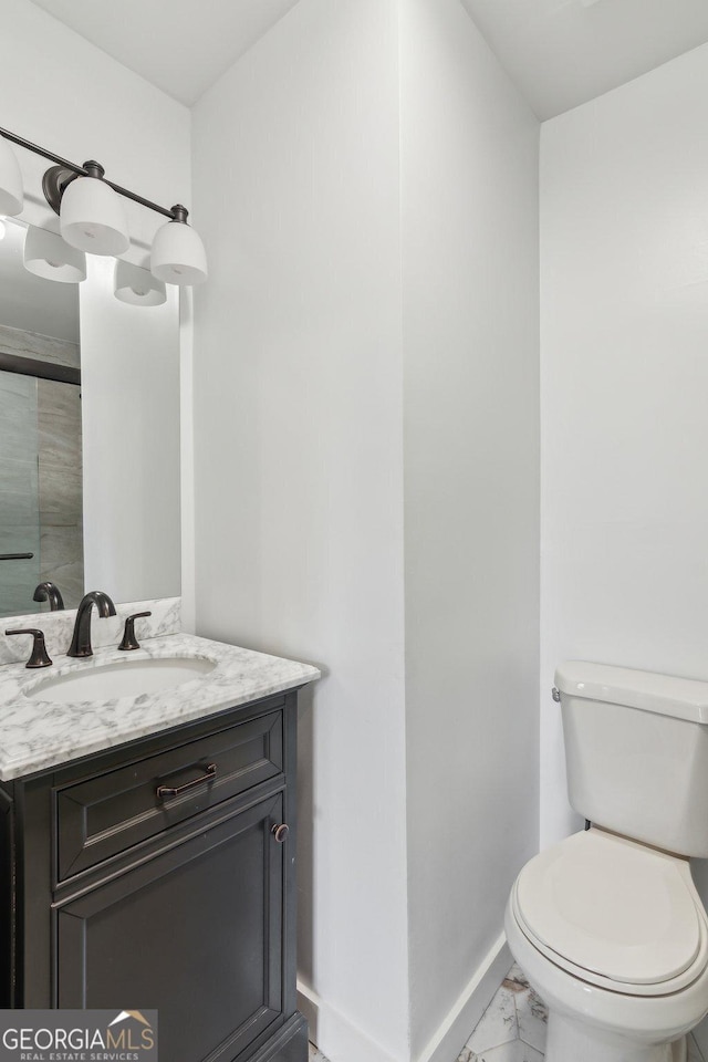 bathroom featuring vanity and toilet