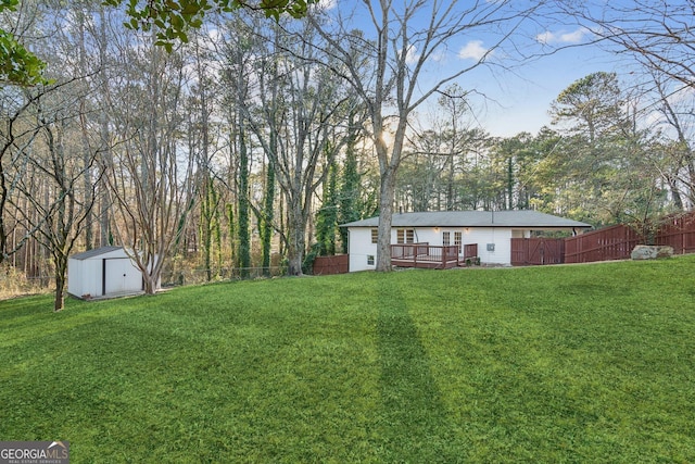 view of yard featuring a deck and a shed