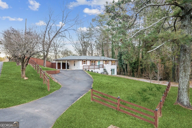 ranch-style home featuring a carport and a front lawn