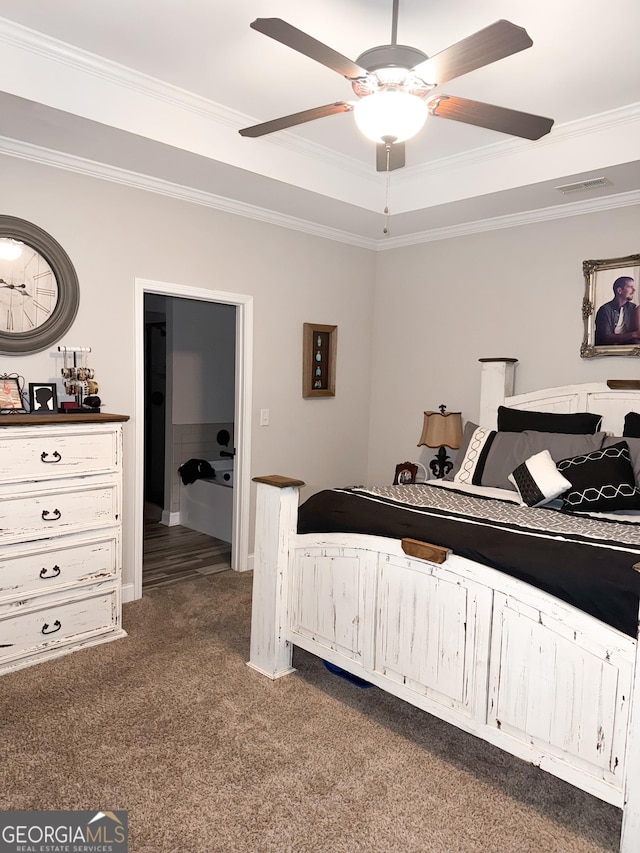 bedroom featuring crown molding, carpet flooring, ceiling fan, and a tray ceiling