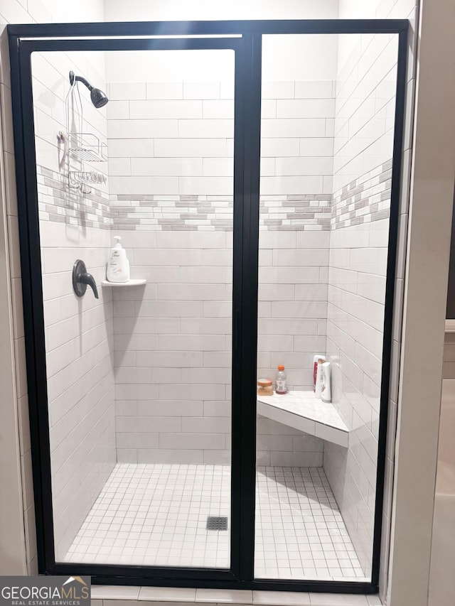 bathroom with a shower with shower door