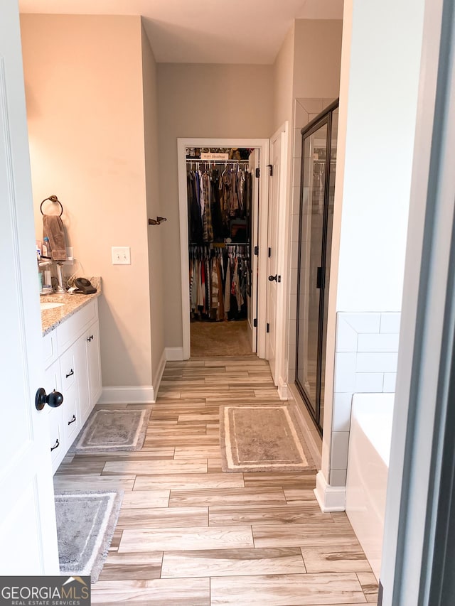 bathroom with plus walk in shower and vanity