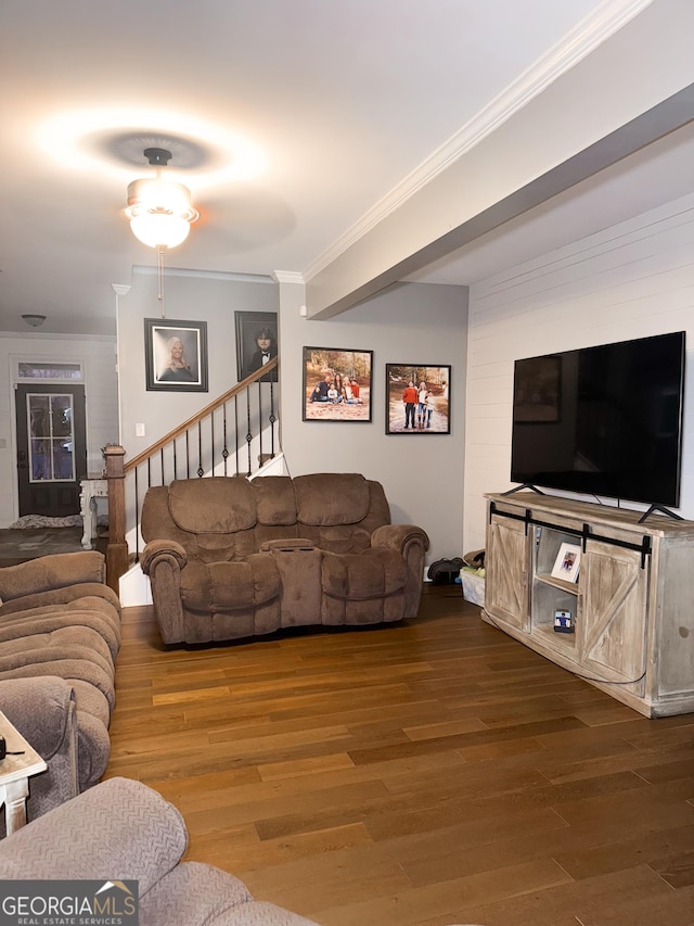 living room with ornamental molding, wood finished floors, and stairway