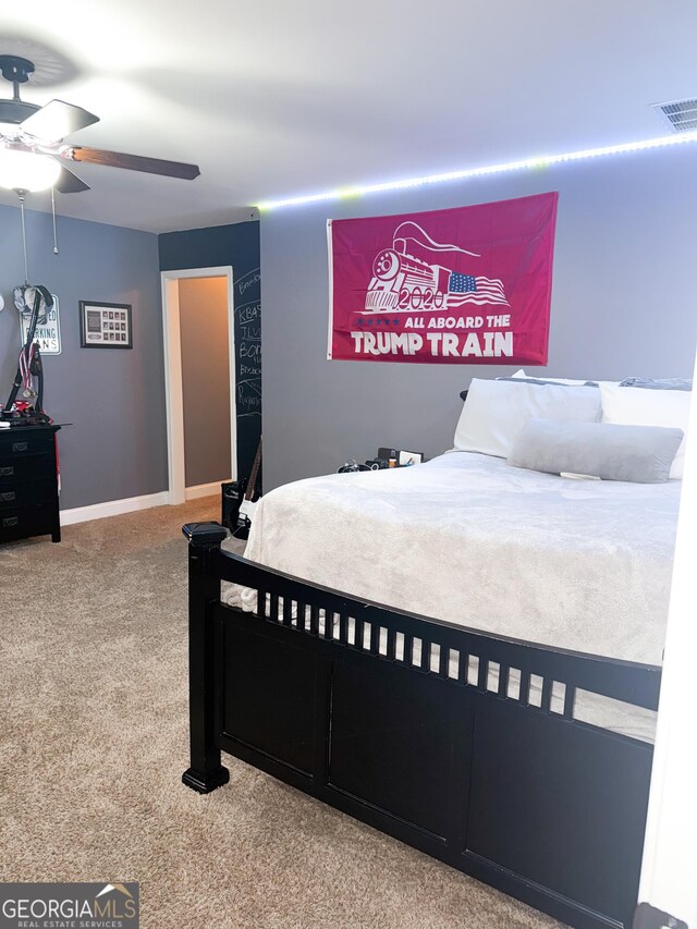 bedroom featuring visible vents, a ceiling fan, carpet, and baseboards
