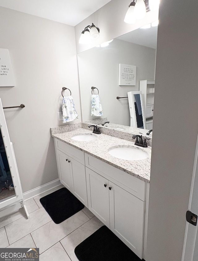 full bathroom featuring double vanity, a sink, and tile patterned flooring