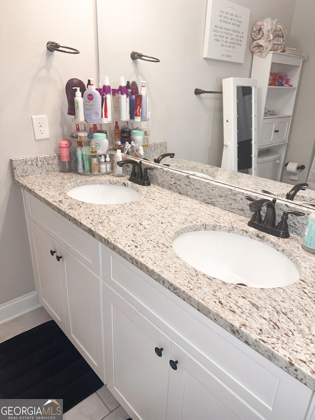 bathroom with vanity and tile patterned flooring