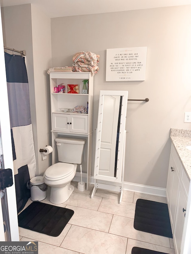 bathroom featuring tile patterned flooring, vanity, and toilet