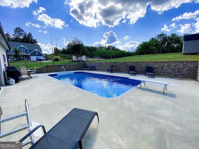 view of pool featuring a patio and a lawn