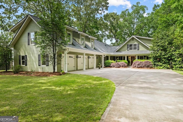 view of front property featuring a garage and a front lawn