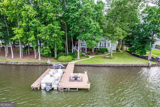 view of dock featuring a water view and a yard