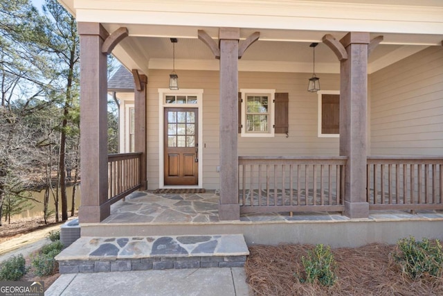 view of exterior entry featuring covered porch