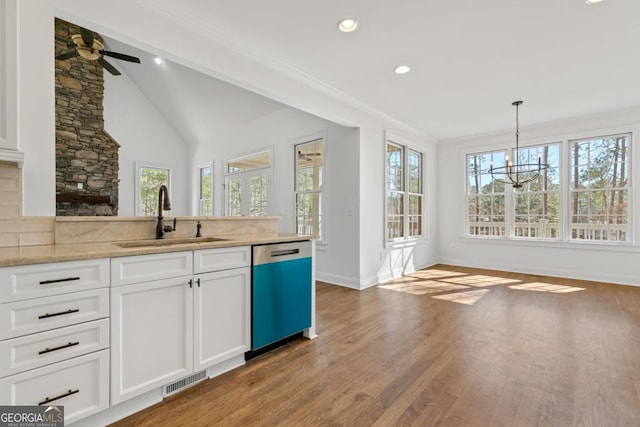 kitchen with white cabinetry, dishwasher, sink, and pendant lighting