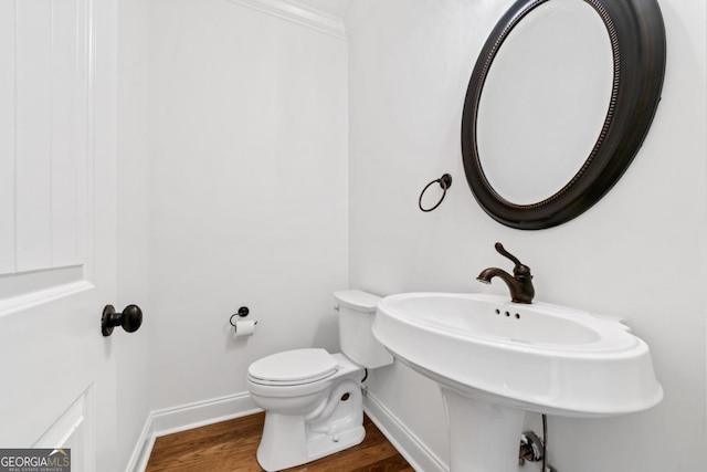 bathroom with ornamental molding, toilet, and hardwood / wood-style floors