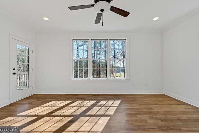 empty room with crown molding, ceiling fan, and dark hardwood / wood-style floors