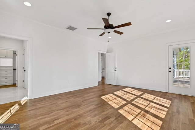 spare room with ceiling fan, ornamental molding, and wood-type flooring