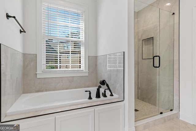 bathroom featuring tile patterned flooring and separate shower and tub