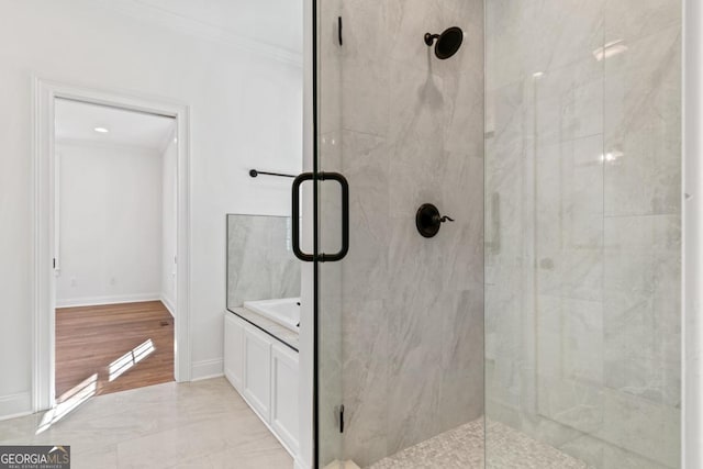 bathroom with ornamental molding and a shower with door