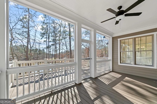 unfurnished sunroom with ceiling fan