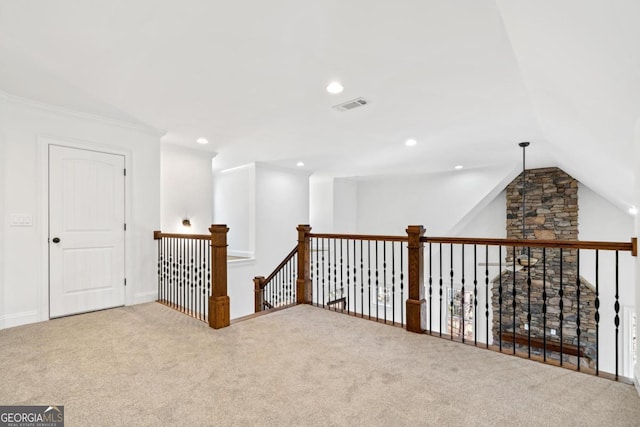 hall featuring crown molding, vaulted ceiling, and carpet