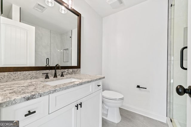 bathroom featuring vanity, walk in shower, and toilet