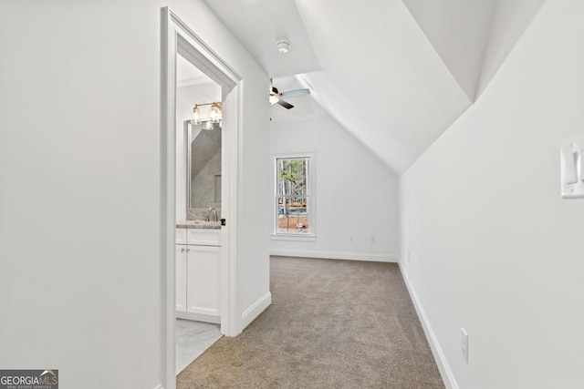 additional living space with lofted ceiling and light carpet