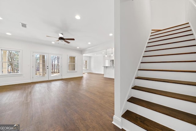 unfurnished living room featuring dark hardwood / wood-style floors, ceiling fan, and french doors