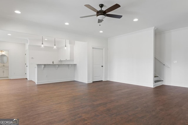 unfurnished living room with ornamental molding, dark wood-type flooring, and ceiling fan