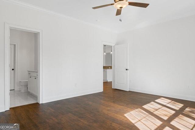 unfurnished bedroom featuring connected bathroom, dark wood-type flooring, ornamental molding, and ceiling fan