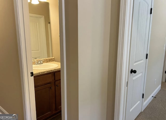 bathroom with vanity and baseboards