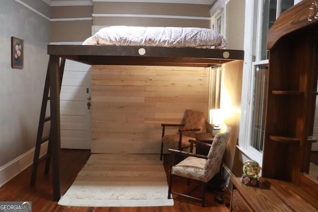 living area with crown molding and hardwood / wood-style floors