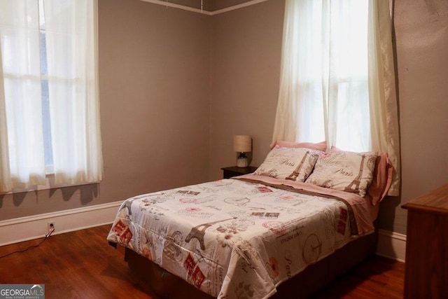 bedroom with dark hardwood / wood-style floors