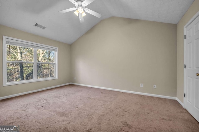 unfurnished bedroom with lofted ceiling, light colored carpet, and ceiling fan