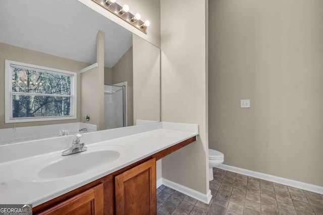 bathroom with vanity, toilet, and a shower with door