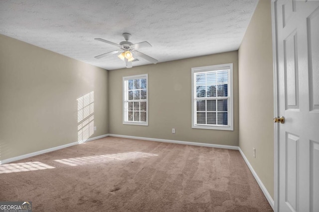 unfurnished room with ceiling fan, light carpet, and a textured ceiling