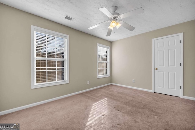 unfurnished room featuring ceiling fan, a textured ceiling, and carpet flooring